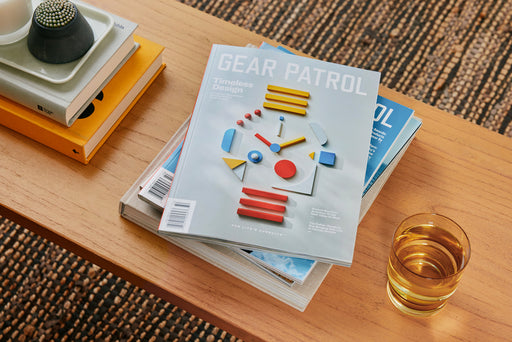 gear patrol magazine, issue twenty-one laying on a wooden table