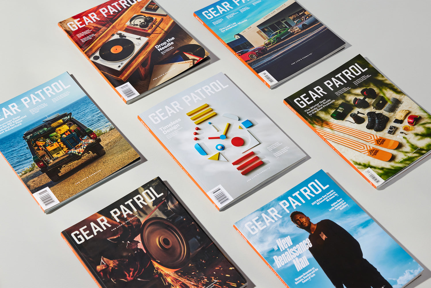 assortment of copies of gear patrol magazine laying on a gray table
