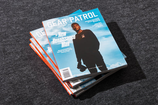 copy of gear patrol magazine, issue nineteen with marques brownlee on the cover holding a camera in his hand as he stands in front of a blue sky | Photo Credit: Matthew Stacey / @matthewstaceystudio