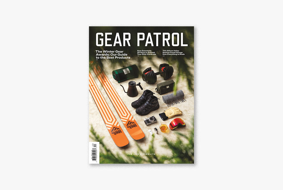 cover of gear patrol magazine issue seventeen which shows a pair of skis, hiking boots, a scarf and other winter gear